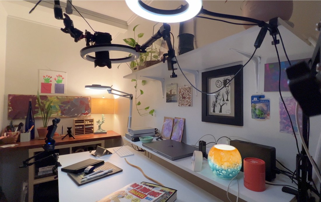 Inside an art studio with lights, camera getting ready to start filming