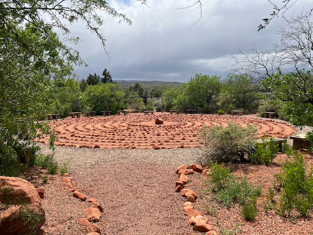 Red stone labyrinth in a natural setting with trees and sky, taken in Utah. Photo by Penelope Wrenn